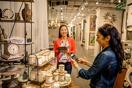 Cashier accepts payment from a customer in retail store