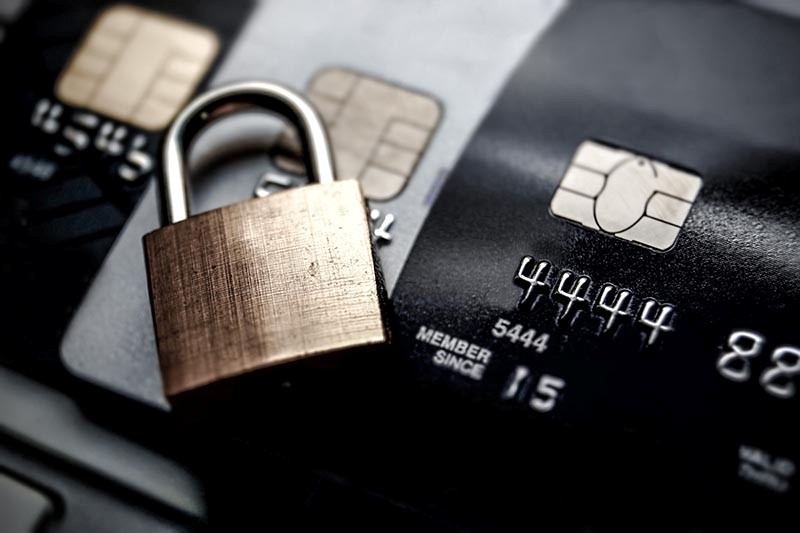 padlock sitting on top of credit cards