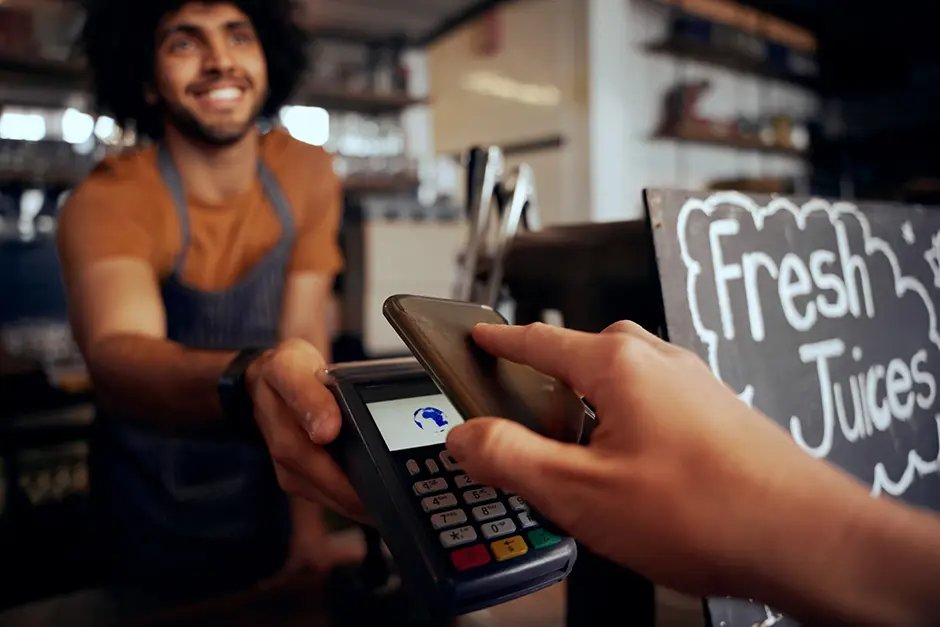 man taking a payment at a juiice bar