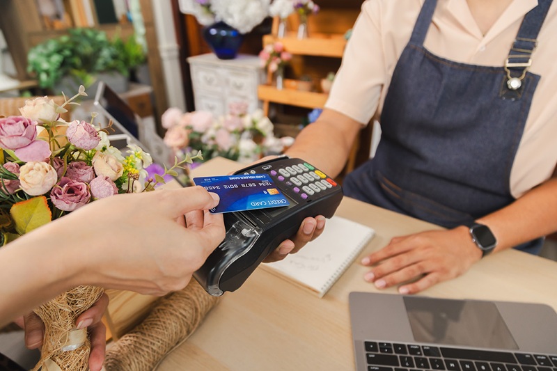 Tapping for payment on terminal in flower shop