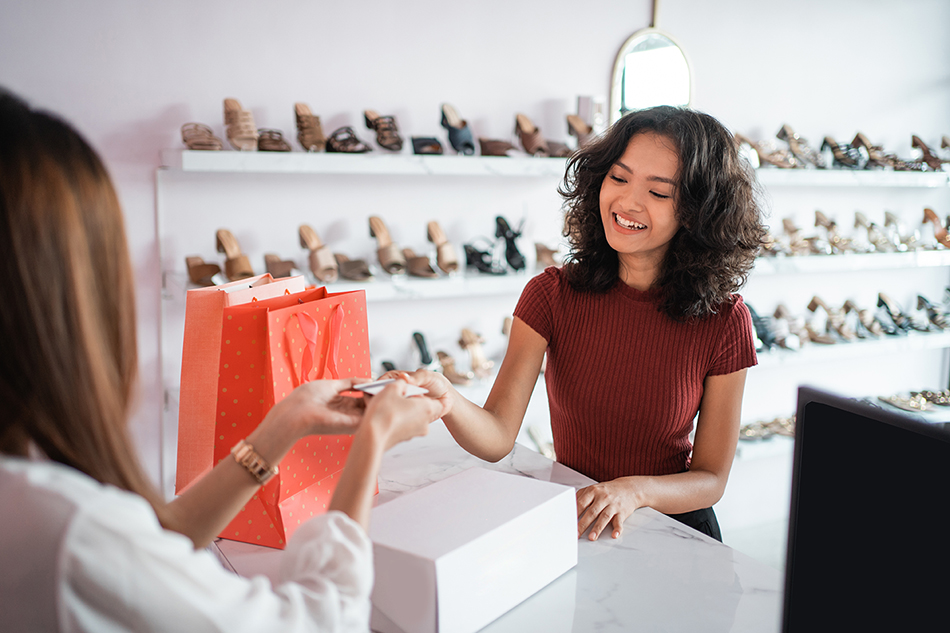 Woman in shoe store making purchase